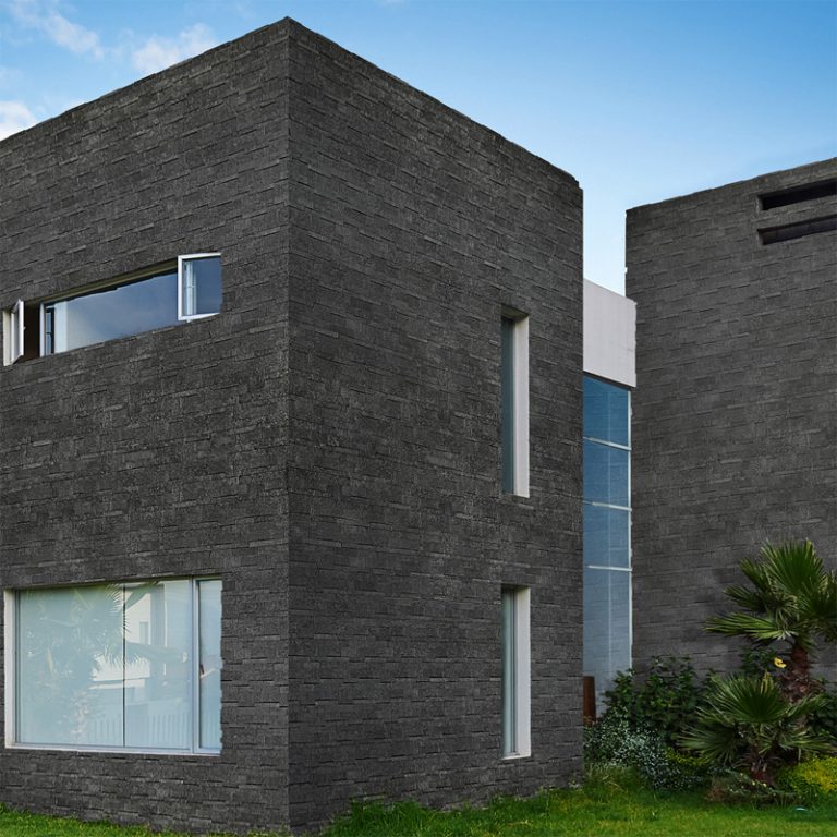 Modern building facade clad in Cliff Black Sapphire flamed and brushed macro wall panels