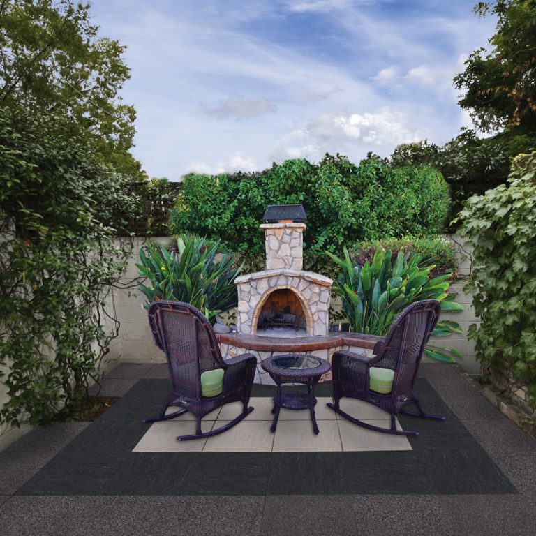 Backyard patio with Bianco Nextone and Nextone Black 24x24 porcelain pavers around an outdoor fireplace