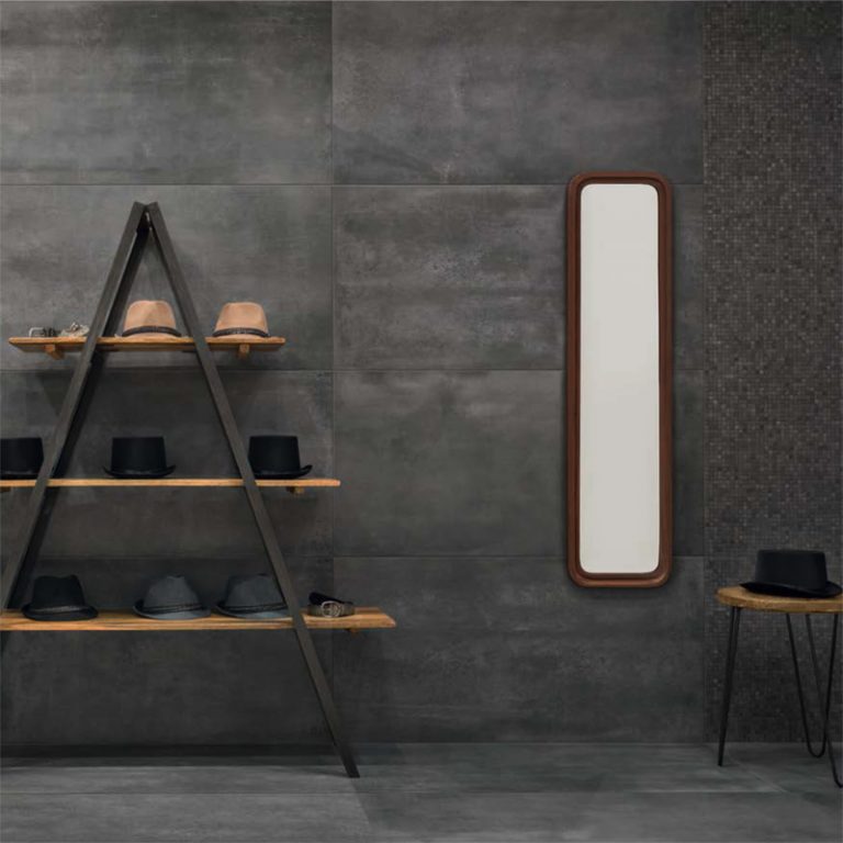 Shop wall in Urbana 12x24 Antracite concrete-look porcelain tile with ladder shelves and a mirror