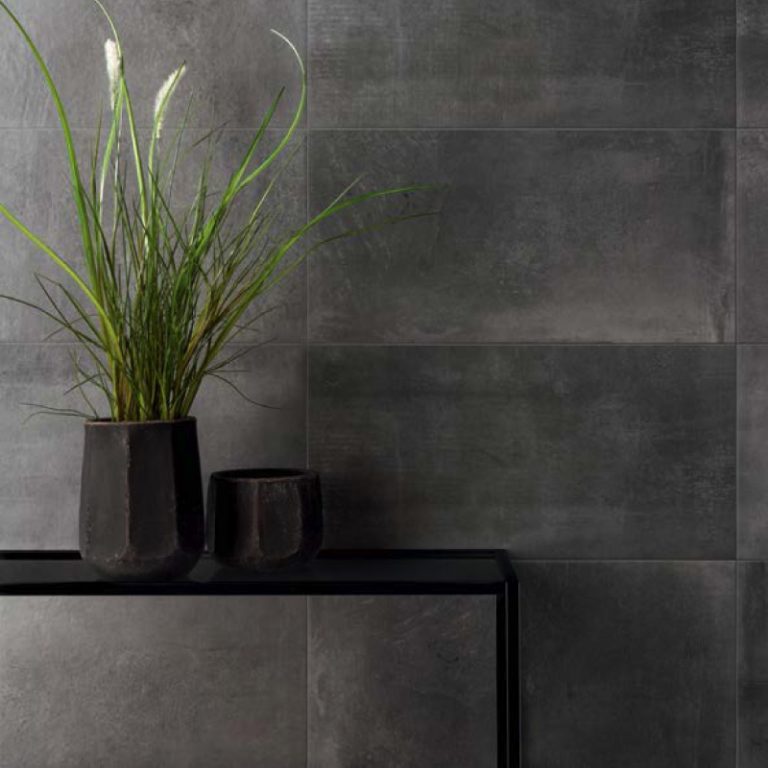 Urbana 12x24 Antracite concrete-look porcelain wall tile behind a console with a plant