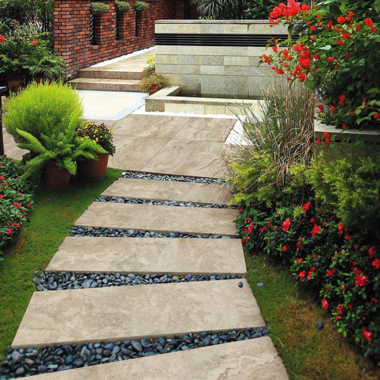 Garden path of Silver Travertine porcelain pavers through flower beds
