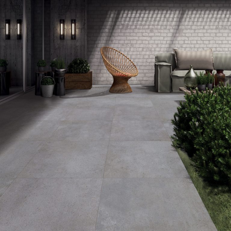 Courtyard with a Silver Limestone 24x24 porcelain paver floor and a rattan chair