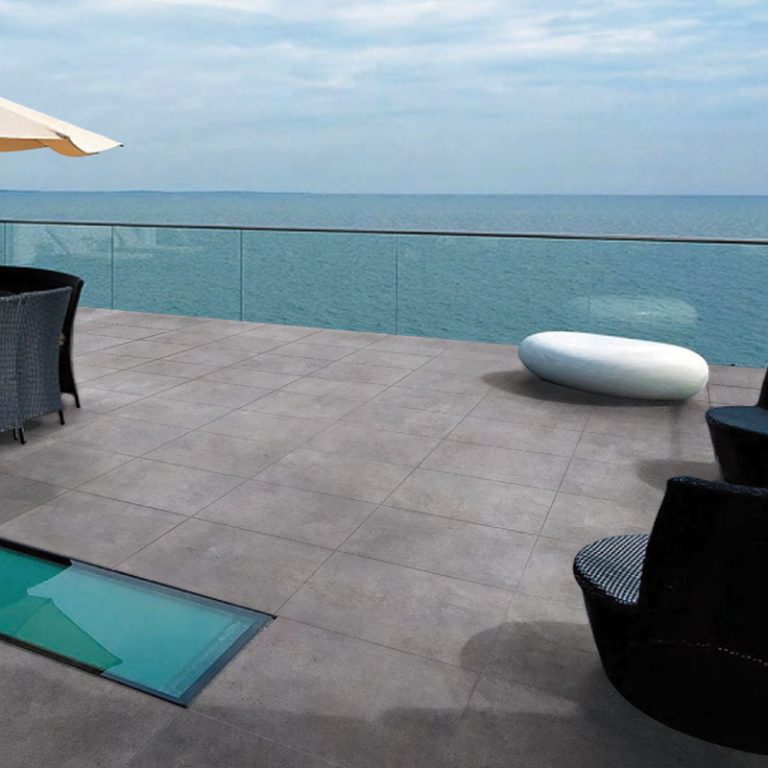 Rooftop terrace with Silver Limestone 24x24 porcelain pavers overlooking the sea