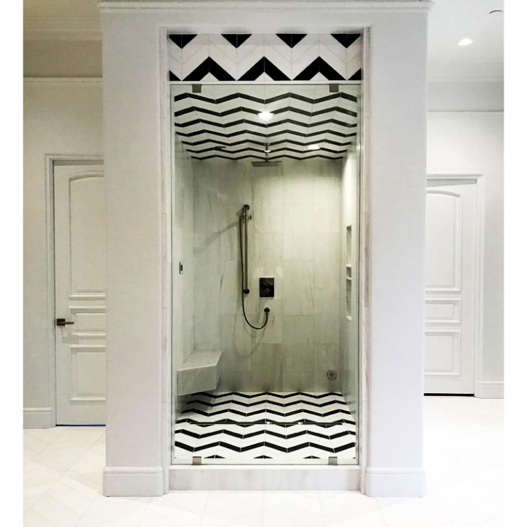 Shower with a Thassos White Extra and Noir Noble polished marble chevron floor and wall band