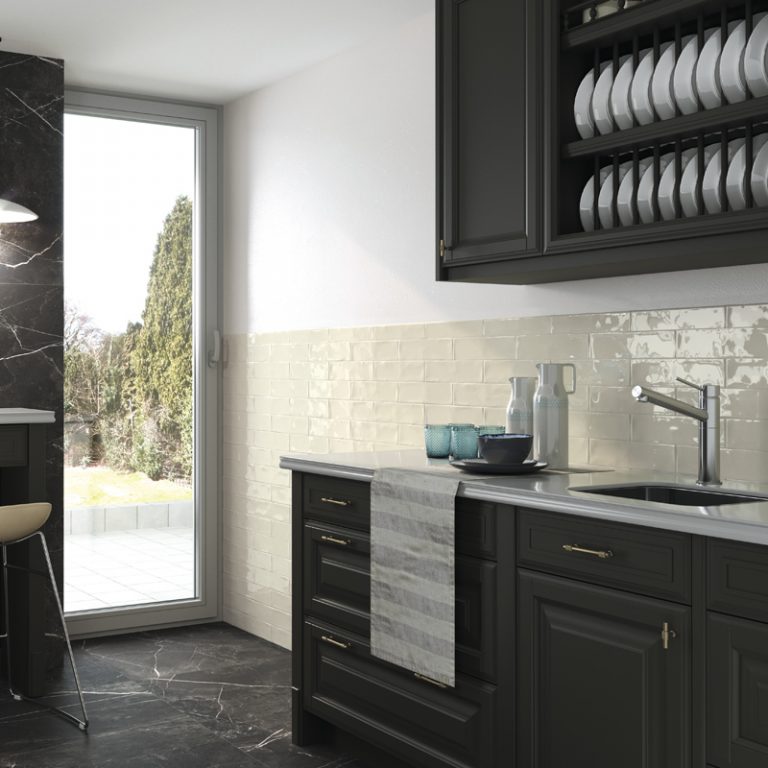 Kitchen backsplash in Ravello 3x12 Natural glossy wall tile with black cabinets