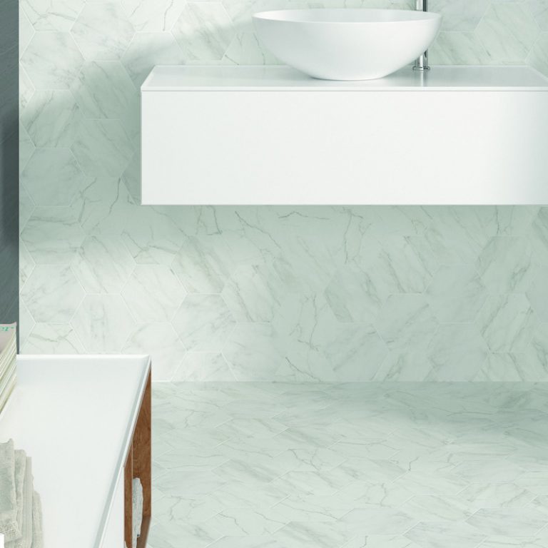Verona White marble-look hexagon tile wall and floor around a floating vessel sink