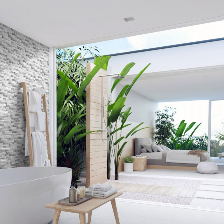 Bathroom with Natura Artico stone-look interlocking porcelain wall panels opening to a garden