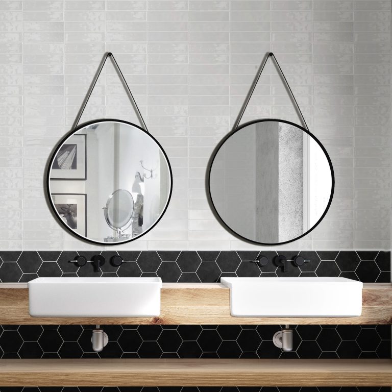Bathroom with Colors White brick wall tile above a Colors Black hexagon tile band and two round mirrors