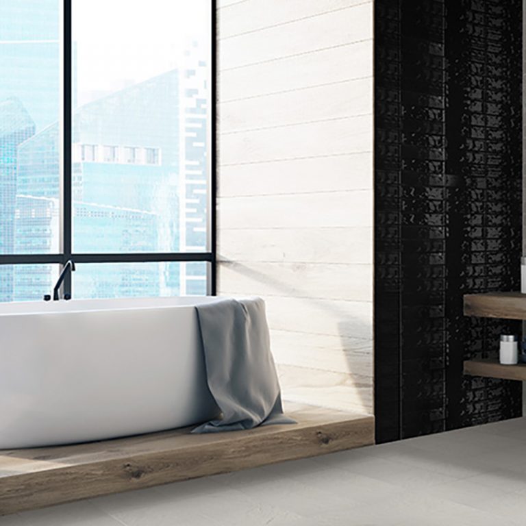 Bathroom with a Colors Black brick tile wall and a Colors Greige porcelain floor beside a tub