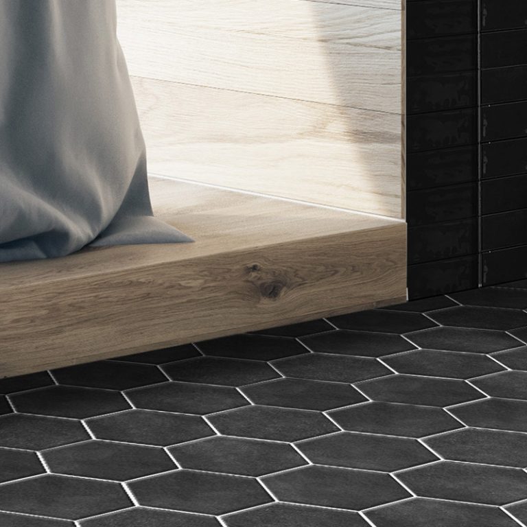 Colors 5-7/8x6-3/4 Black hexagon tile floor beside a wood platform tub