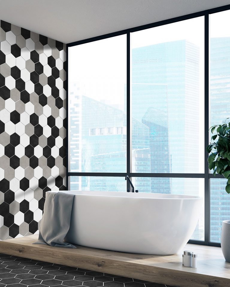 Colors 5-7/8x6-3/4 black, white and greige hexagon tile on the wall and floor around a freestanding tub