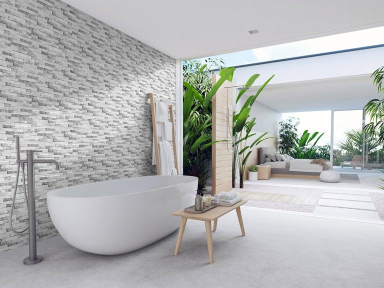 Bathroom with a Natura Artico feature wall in stone-look interlocking porcelain wall panels and a freestanding tub