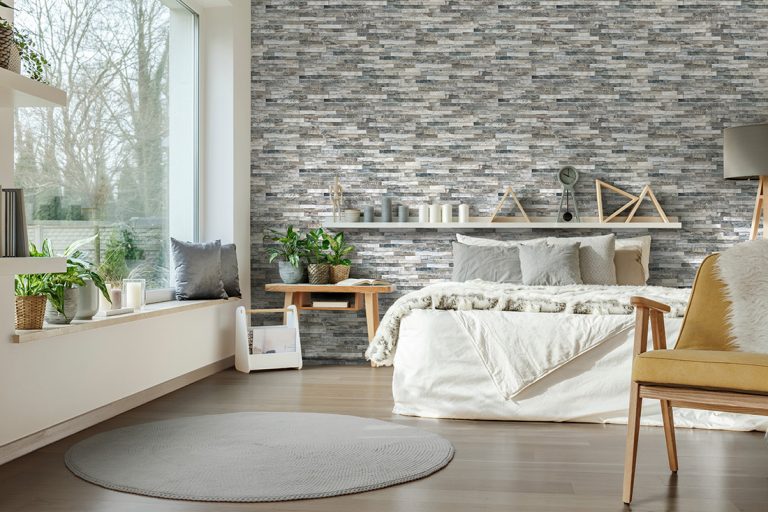 Bedroom with a Natura Giungla accent wall in stone-look interlocking porcelain wall panels