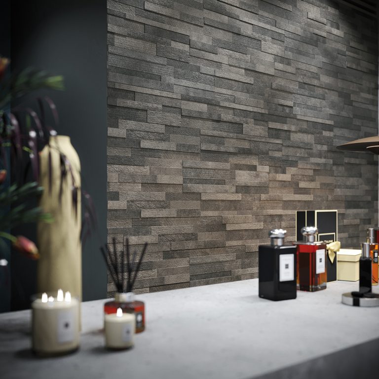 Volcano 6x24 Dark cement-look wall panels behind a display of fragrance bottles