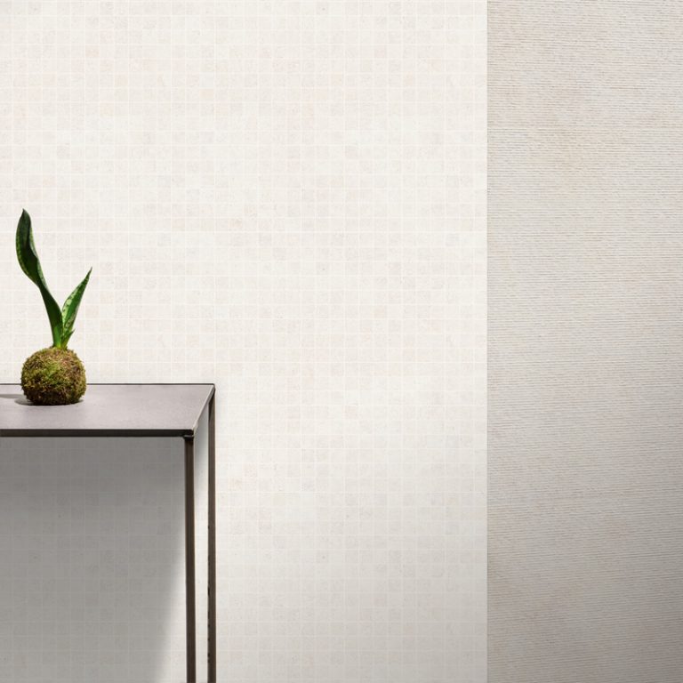 Wall in Silky Stone Light 24x48 porcelain tile and 2x2 square mosaic with a console