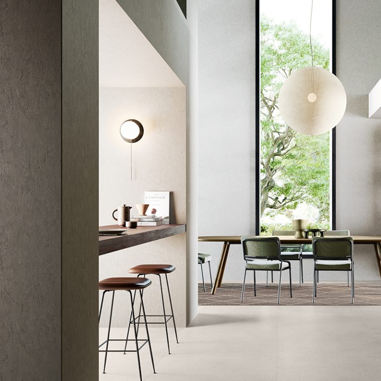 Open kitchen and dining area with Silky Stone Greige 24x48 and 24x24 porcelain tile on the floor and walls