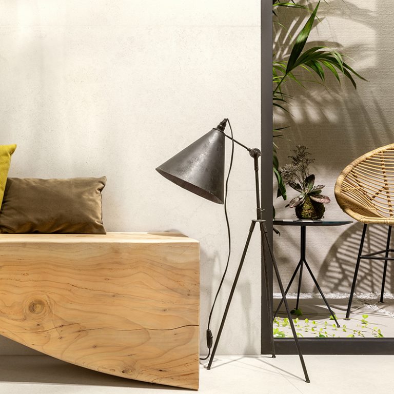 Silky Stone Light 24x48 porcelain tile floor and wall with a wood bench and floor lamp
