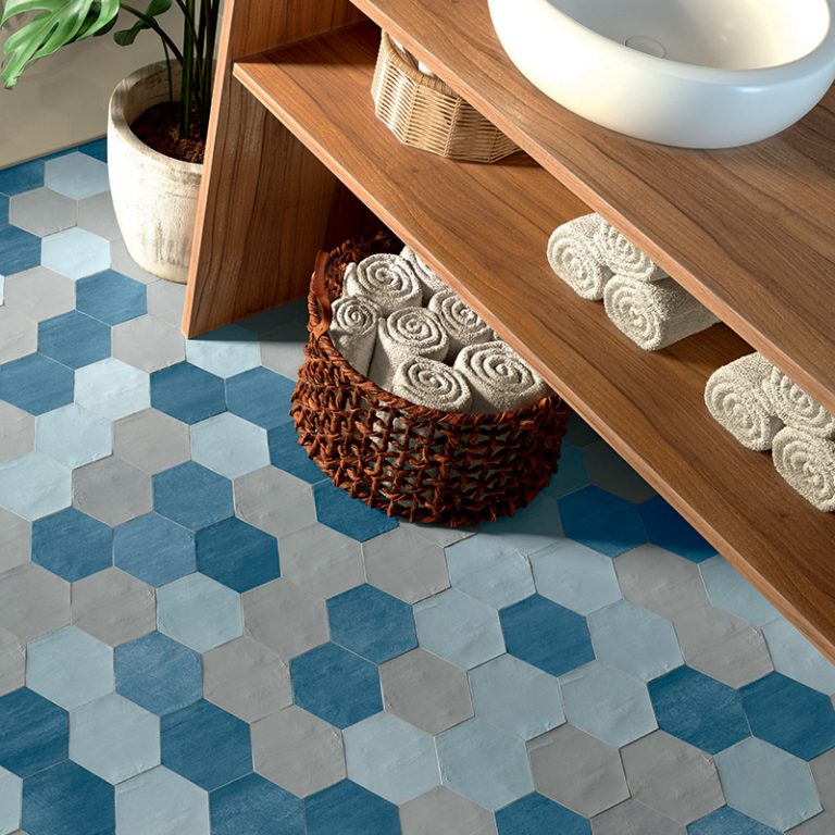Switch 4x4-1/2 Blue and White hexagon tile floor under a wood vanity with rolled towels