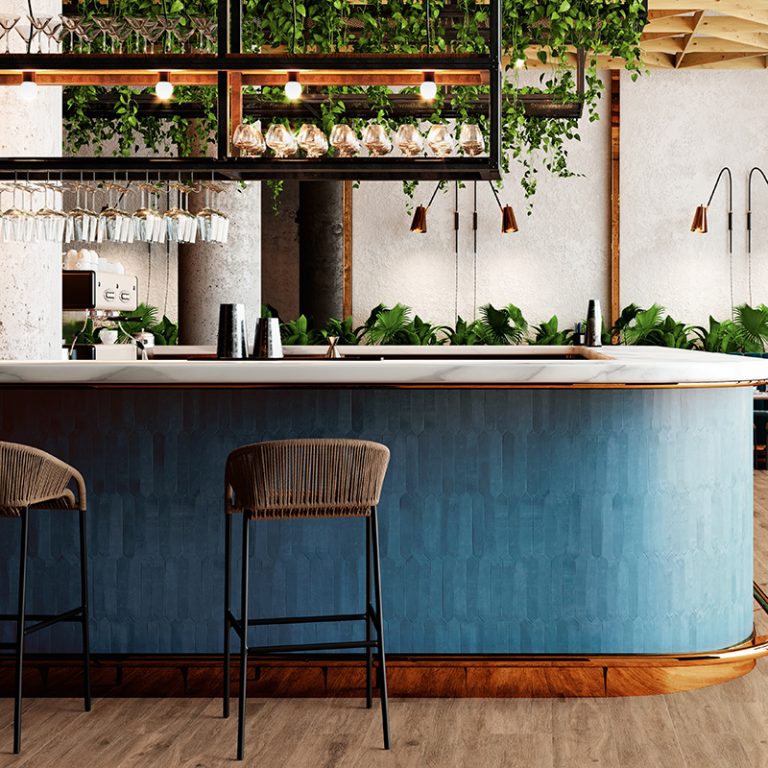 Bar with a curved counter clad in Switch 2x10 Dark Blue picket tile