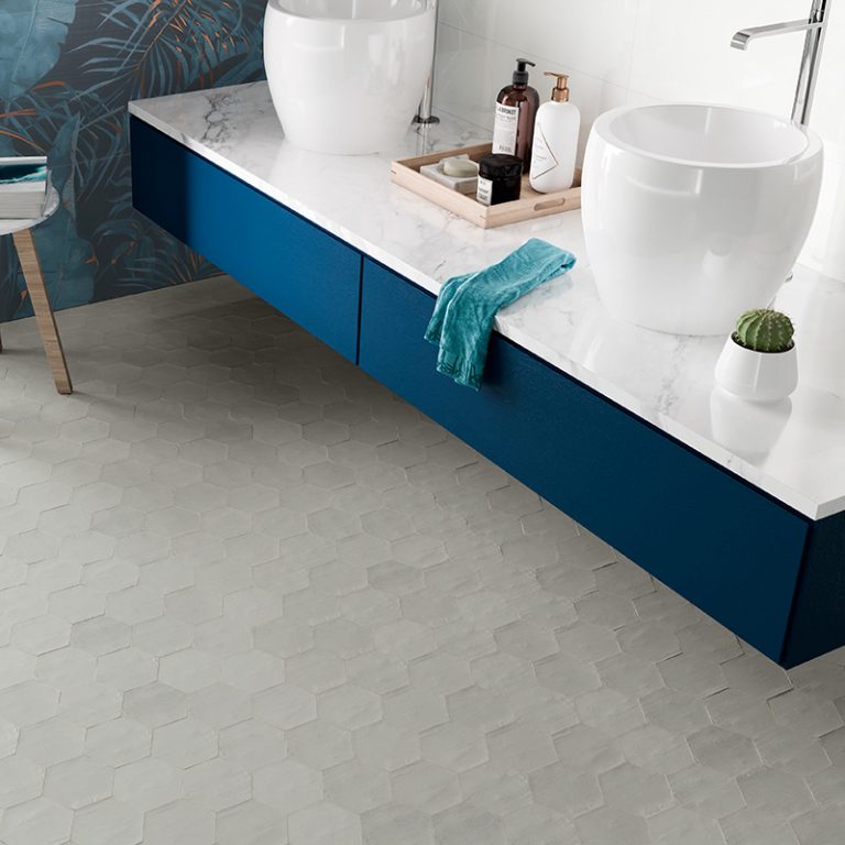 Bathroom with a Switch 4x4-1/2 Gray hexagon tile floor and a blue double vanity