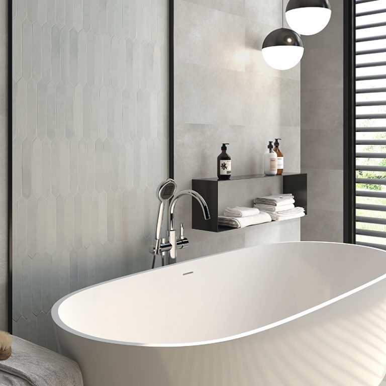 Bathroom with Switch 2x10 Gray picket wall tile behind a freestanding tub