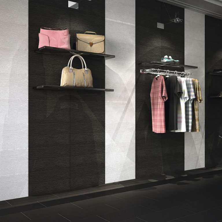 Boutique wall with Ontario 12x22 Blanco raked stone-look wall panels and clothing displays