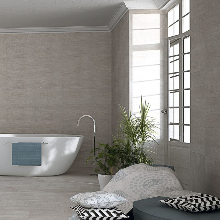 Bathroom with Ontario 12x22 Gris raked stone-look wall panels and a freestanding tub by a tall window
