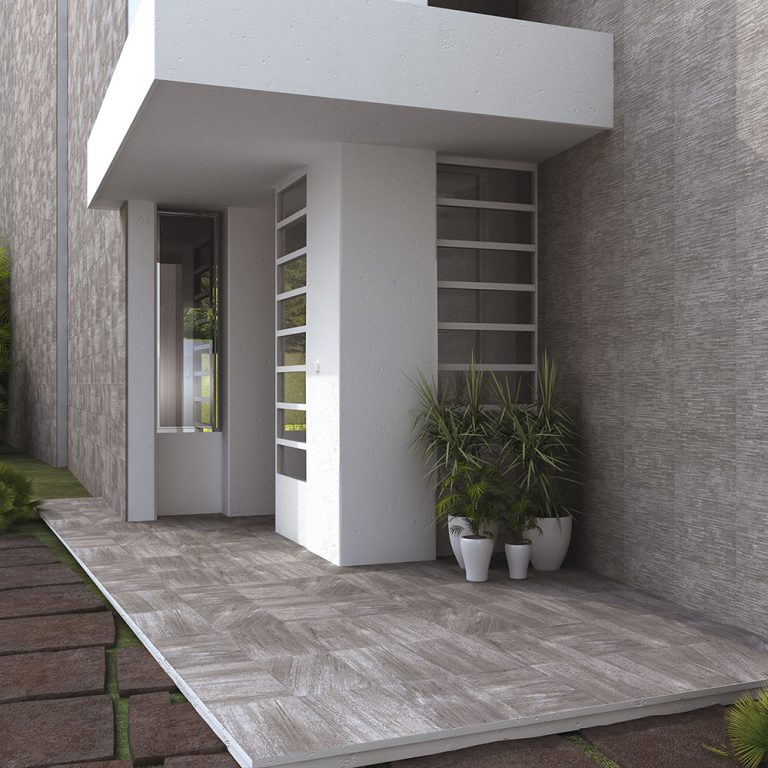 Front entrance clad in Ontario 12x22 Antracita raked stone-look wall panels with potted plants