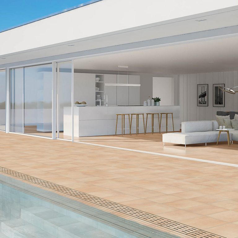 Poolside terrace with a Memory 14x14 Sandy porcelain tile deck leading to an open living room