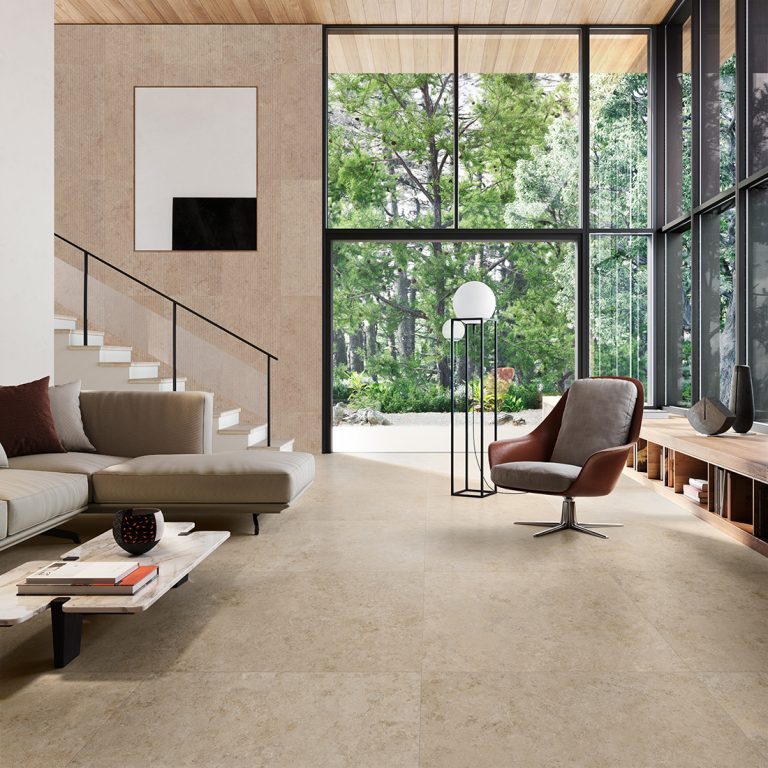 Living room with an Upstone 24x48 Jura Beige stone-look porcelain tile floor and wall