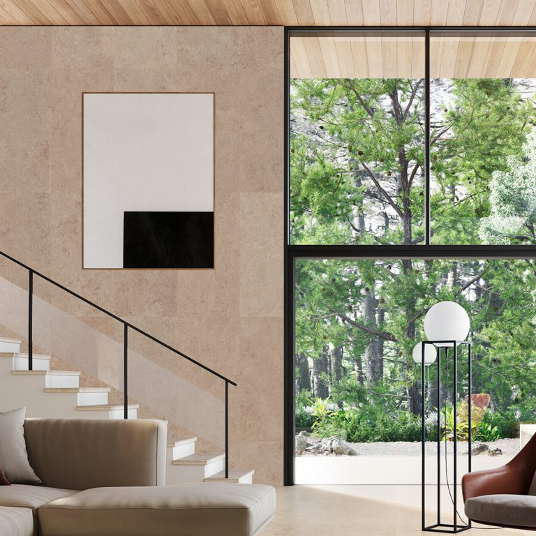 Double-height living room with an Upstone 24x48 Jura Beige porcelain tile wall and a staircase