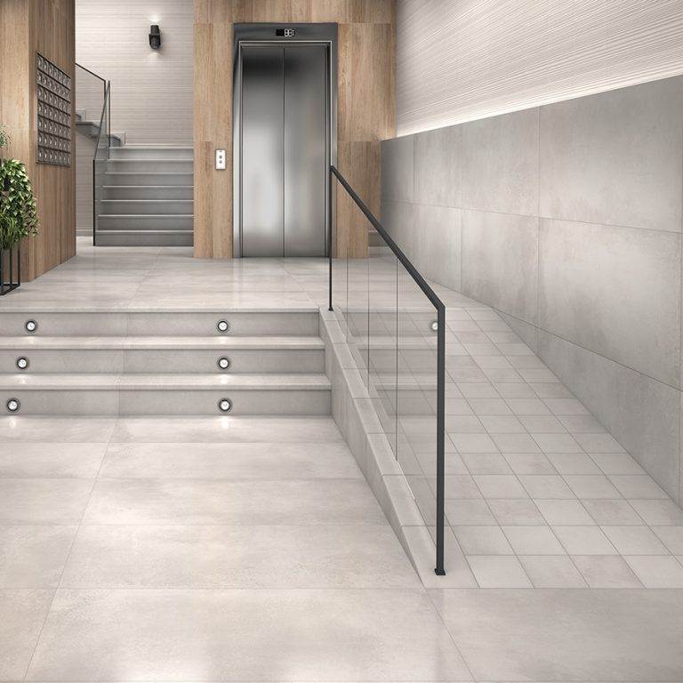 Entry with Memory Opal porcelain tile on the floor and stairs and a glass railing
