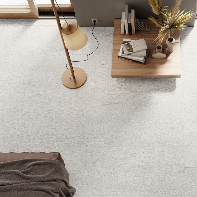 Overhead view of an Upstone 24x48 Duke Bianco stone-look porcelain tile floor with a desk