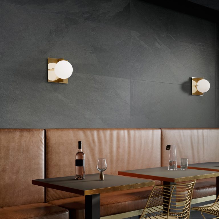 Restaurant with Upstone 24x48 Mustang Nero porcelain tile walls and leather banquettes