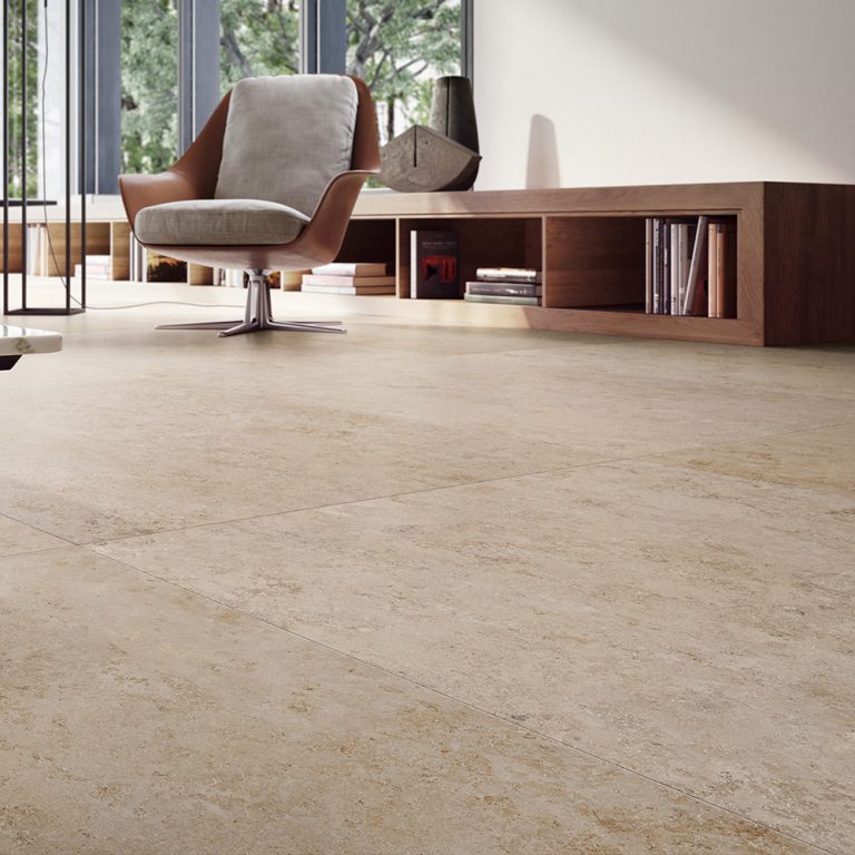 Living room with an Upstone 24x48 Jura Beige porcelain tile floor and a low wood console