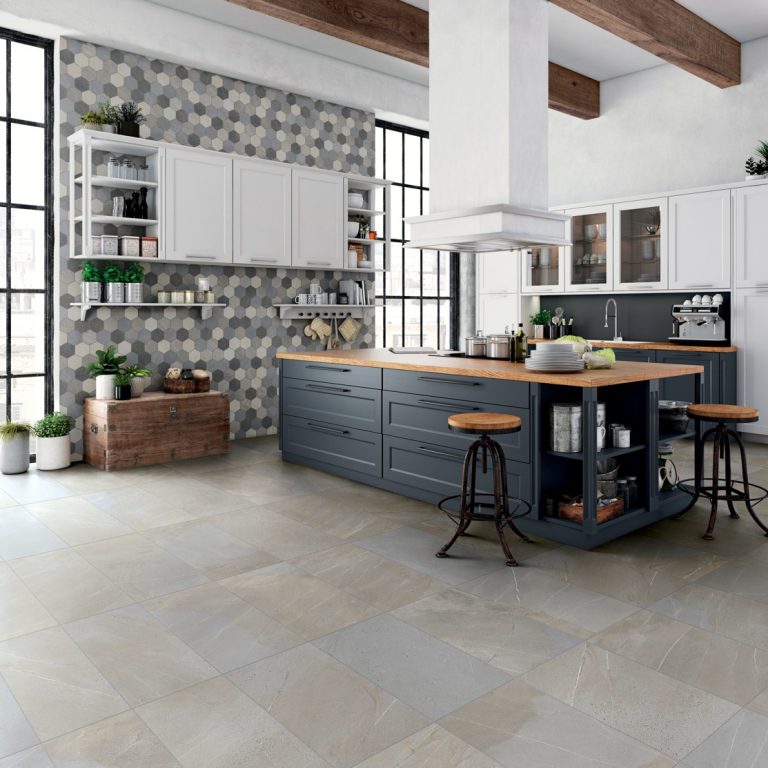 Kitchen with an Allure 12x24 Horizon stone-look porcelain tile floor and a navy island