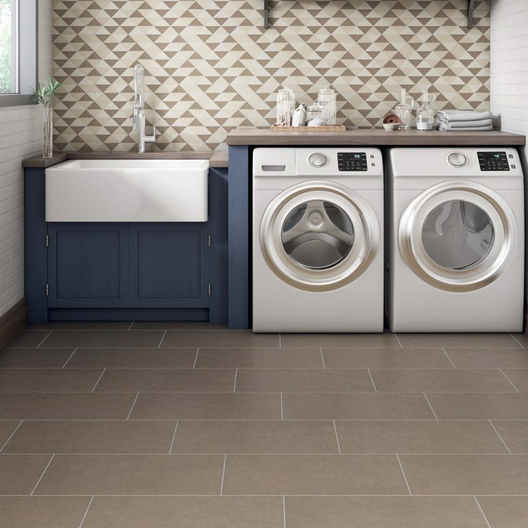 Laundry room with a Eureka 12x24 Tobacco brown porcelain tile floor and a side-by-side washer and dryer