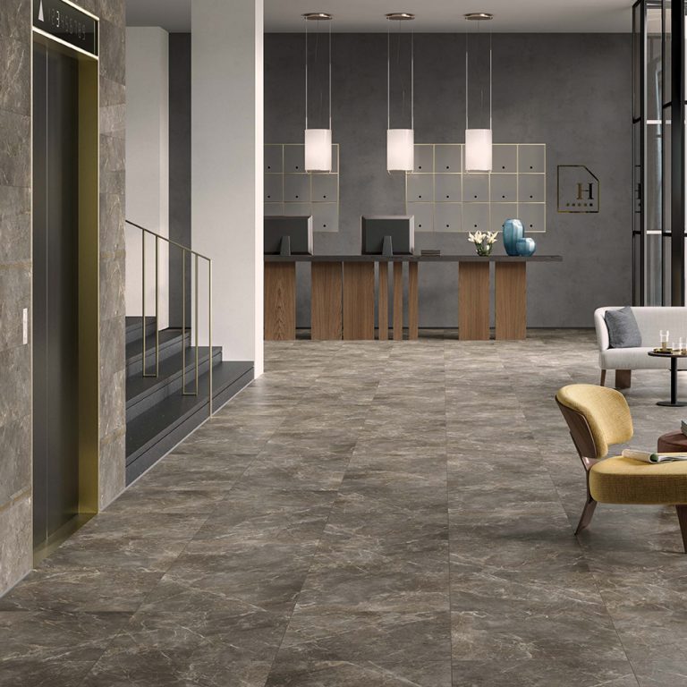 Apartment lobby with a Noble Charm 12x24 stone-look porcelain tile floor and a reception bar