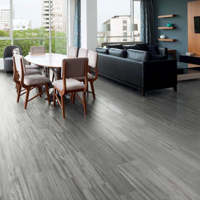Open living and dining room with a Noble Beauty 12x24 gray porcelain tile floor