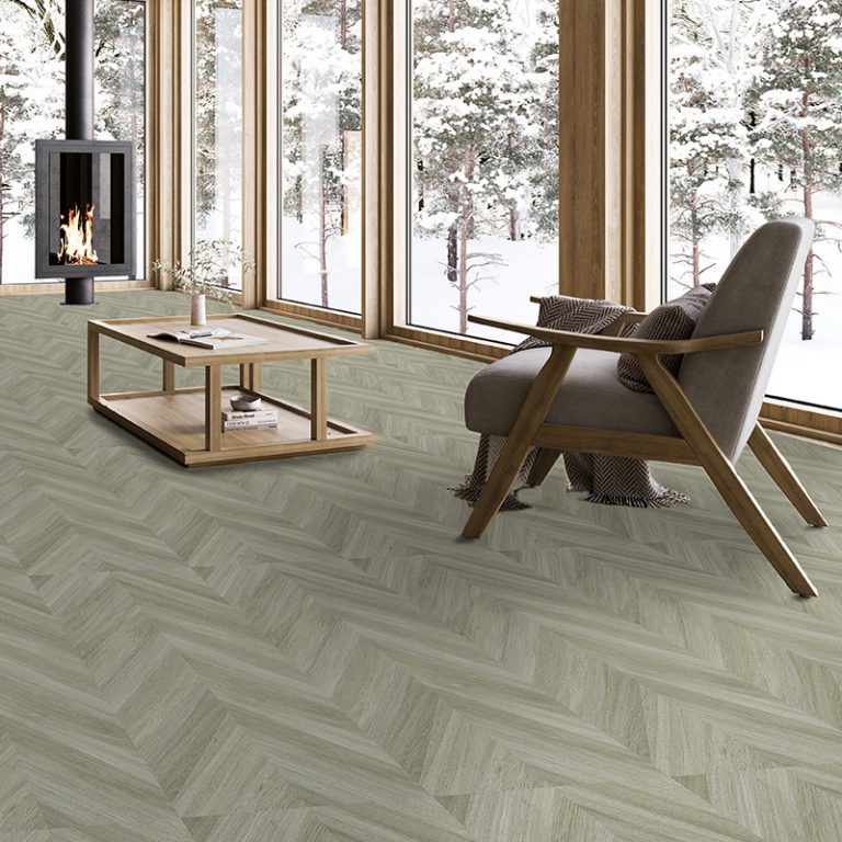 Living room with a Baywood Manhattan Silver wood-look porcelain chevron floor, wood stove and snowy view