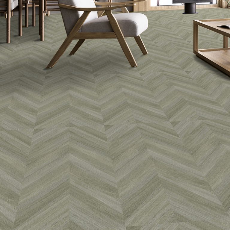 Baywood Manhattan 24x48 Silver wood-look porcelain tile floor in a chevron pattern with a lounge chair