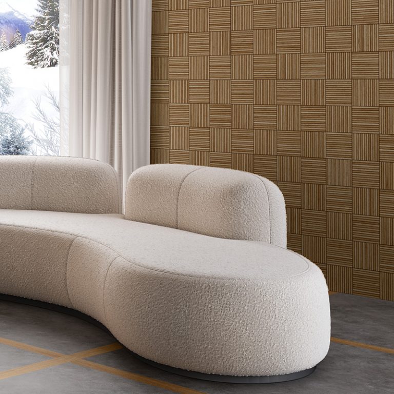 Baywood Redondo 24x48 Natural wood-look porcelain tile in a parquet pattern on a wall behind a curved sofa