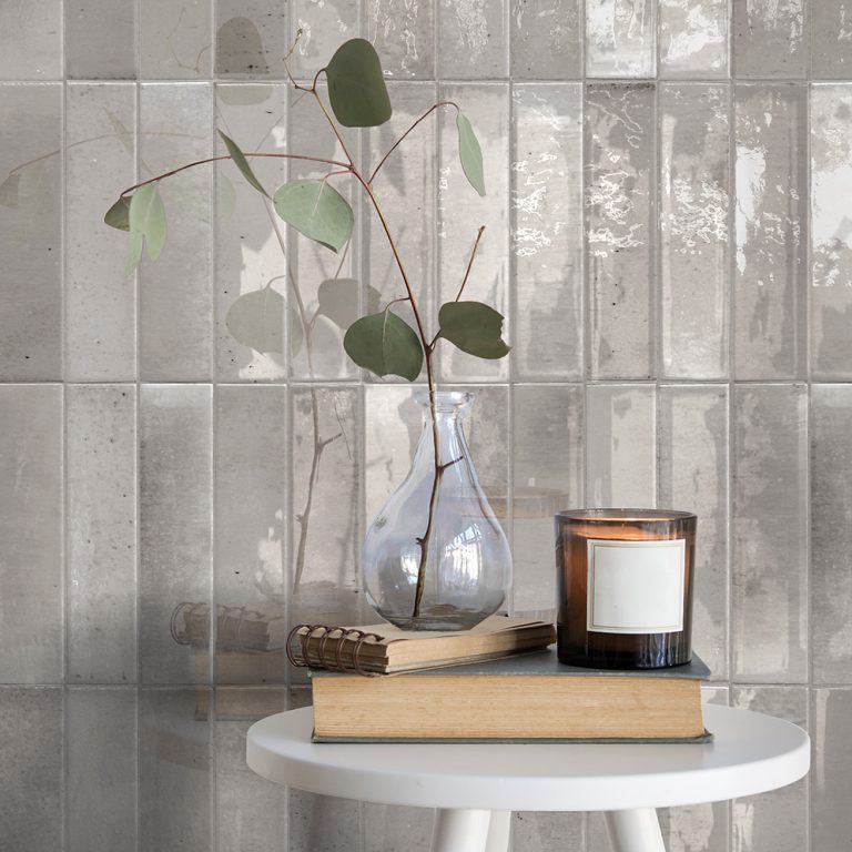 Posh 2-3/8x9-7/8 gray glossy brick tile backsplash with a vase and candle