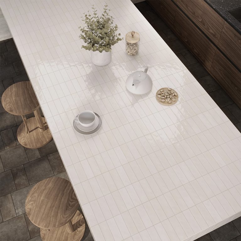 Kitchen island countertop covered in Refined 2x6 white porcelain tile with wood stools