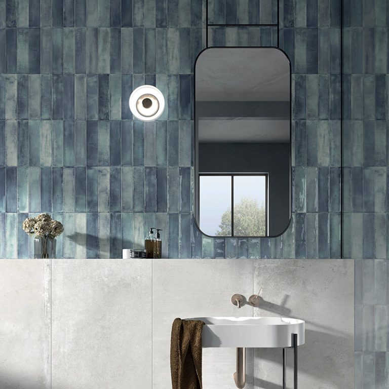 Bathroom with Stack 12x24 blue glossy porcelain tile on the upper wall above a wall-mounted sink