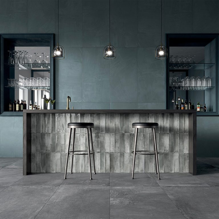 Home bar with Stack 12x24 gray porcelain tile on the walls and bar front
