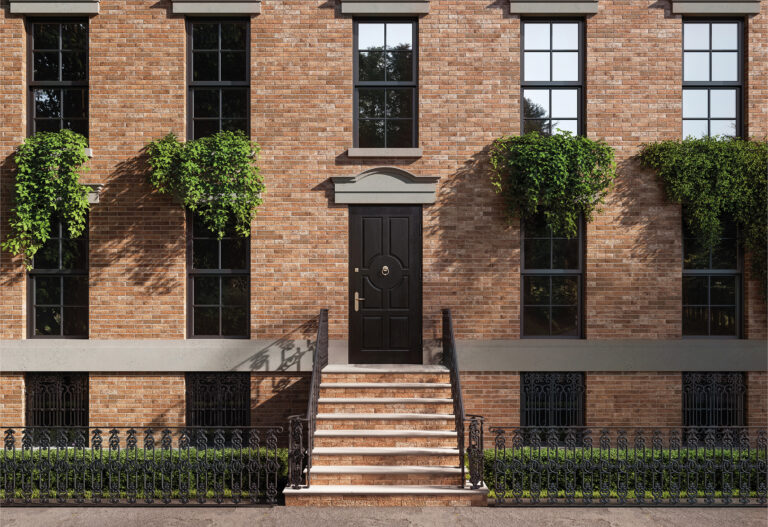 Brick townhouse facade clad in Brickhouse Classic red brick with front steps and an iron fence