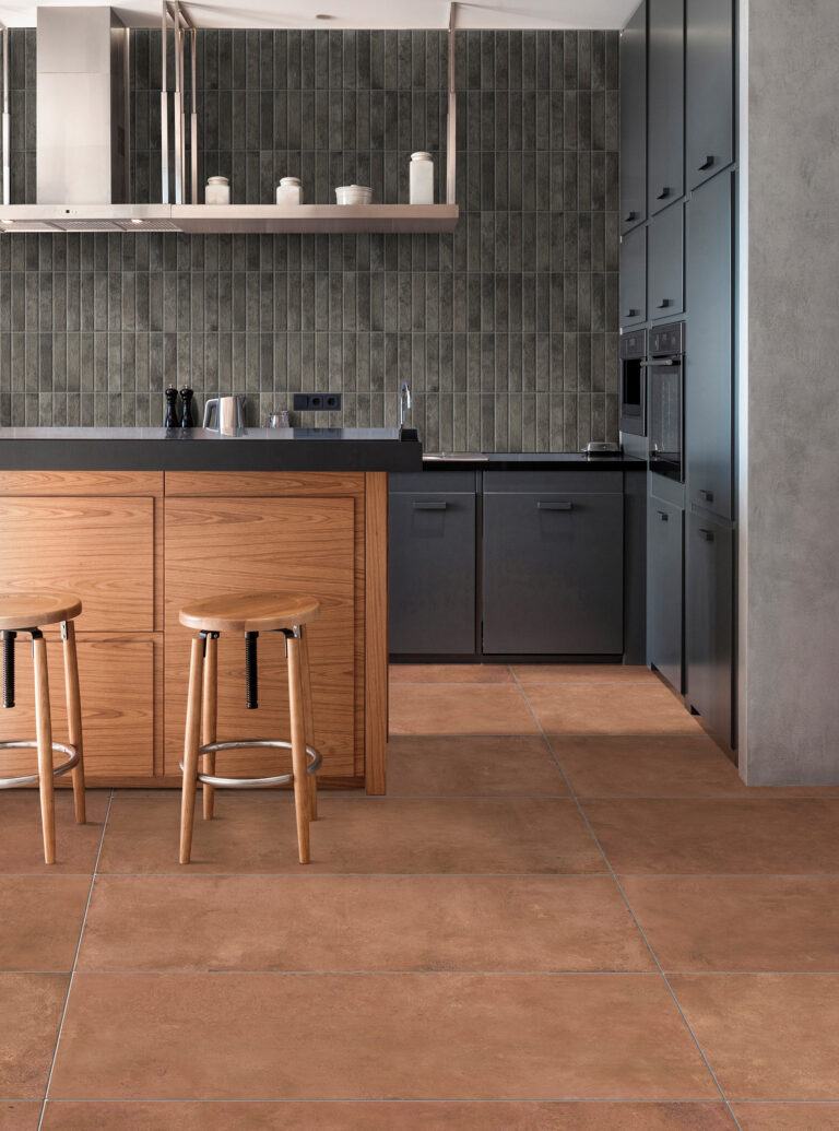Kitchen with a Brickhouse Smoke brick backsplash, wood island and terracotta floor
