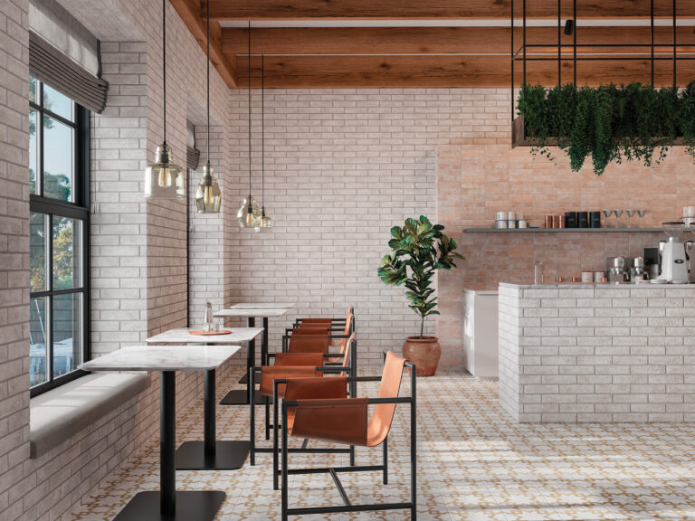 Cafe with Brickhouse White and Buff brick on the walls and counter, pendant lights and orange chairs