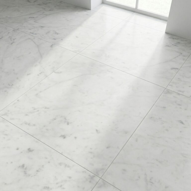 Close-up of Bianco Carrara 12x12 honed marble floor tile with soft gray veining and a window in the background